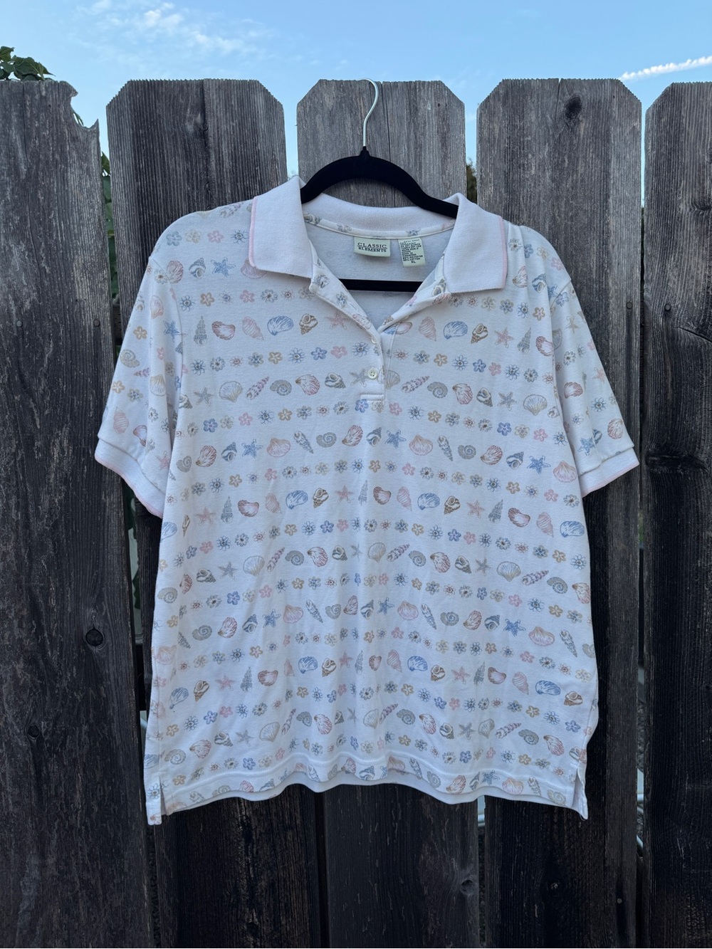 Classic Elements Short Sleeve Polo in White with Pastel Seashell Print